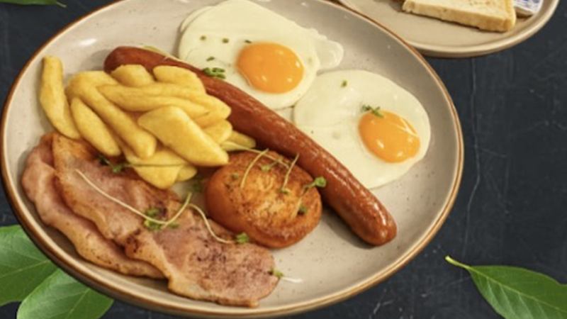 Full breakfast plate with eggs, sausage, bacon, hashbrown and chips